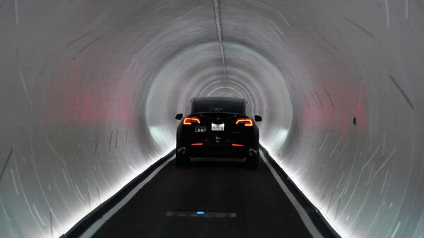 A Tesla car drives through a tunnel in the Las Vegas Convention Center Loop, an underground tunnel developed by Elon Musk's The Boring Company, Tuesday, June 8, 2021, in Las Vegas. - Sputnik International