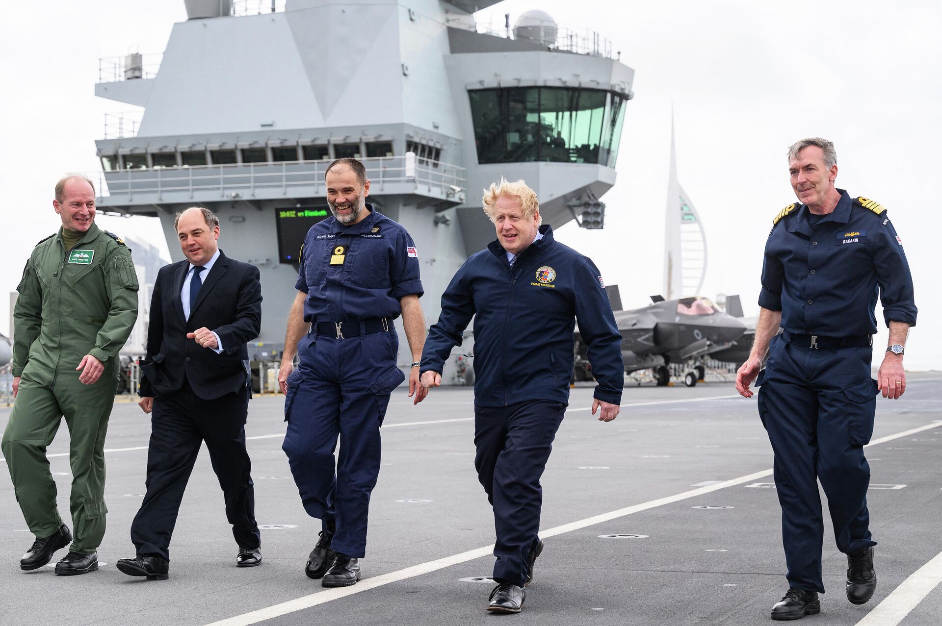 (L-R) Air Chief Marshal Sir Mike Wigston, Defence Secretary Ben Wallace, Commodore Steve Moorhouse, British Prime Minister Boris Johnson and First Sea Lord Admiral Tony Radakin walk on the flight deck as they tour HMS Queen Elizabeth aircraft carrier in Portsmouth, southwest England prior to its departure for Asia in its first operational deployment on May 21, 2021 - Sputnik International, 1920, 08.01.2022