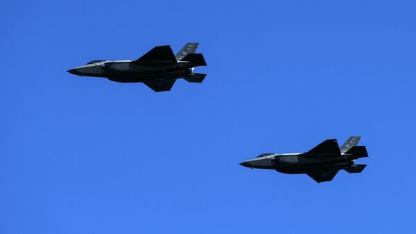 Two US Air Force Lockheed Martin F-35 fighter jets fly over the beach of Houlgate, north-western France, on June 6, 2021.  - Sputnik International