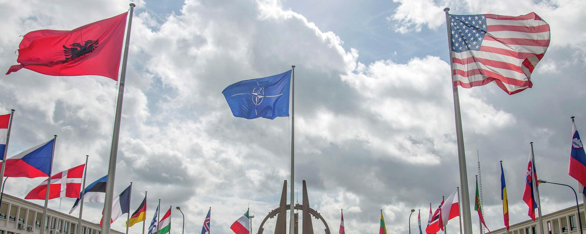 Flags of member nations flap in the wind outside NATO headquarters in Brussels on Friday, Aug. 29, 2014.  - Sputnik International, 1920, 19.02.2022