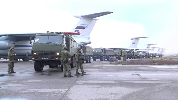 Russian service members and military vehicles are seen upon arrival at Almaty airport, as part of a peacekeeping mission of the Collective Security Treaty Organisation, in Almaty, Kazakhstan, in this still image from video released by Russia's Defence Ministry January 9, 2022 - Sputnik International