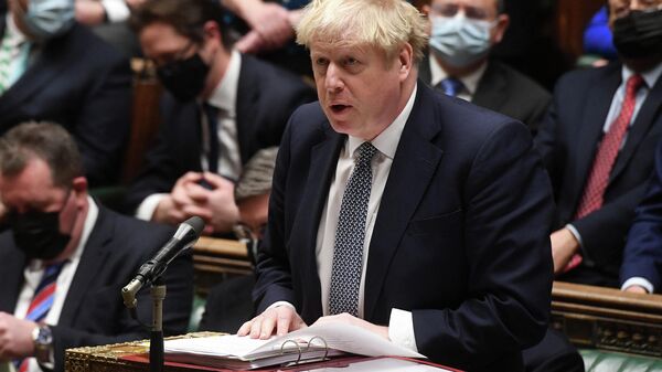 A handout photograph released by the UK Parliament shows Britain's Prime Minister Boris Johnson attending Prime Minister's Questions (PMQs) in the House of Commons in London on January 12, 2022 - Sputnik International