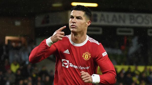 Manchester United's Portuguese striker Cristiano Ronaldo celebrates after scoring the opening goal from the penalty spot during the English Premier League football match between Norwich City and Manchester United at Carrow Road Stadium in Norwich, eastern England, on December 11, 2021 - Sputnik International