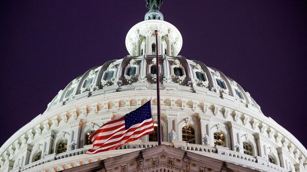 A flag of the United States is seen at halfstaff on the U.S. Capitol building during a prayer vigil in observance of the first anniversary of the January 6, 2021 attack on the Capitol by supporters of former President Donald Trump, on Capitol Hill in Washington, U.S., January 6, 2022. REUTERS/Jonathan Ernst - Sputnik International