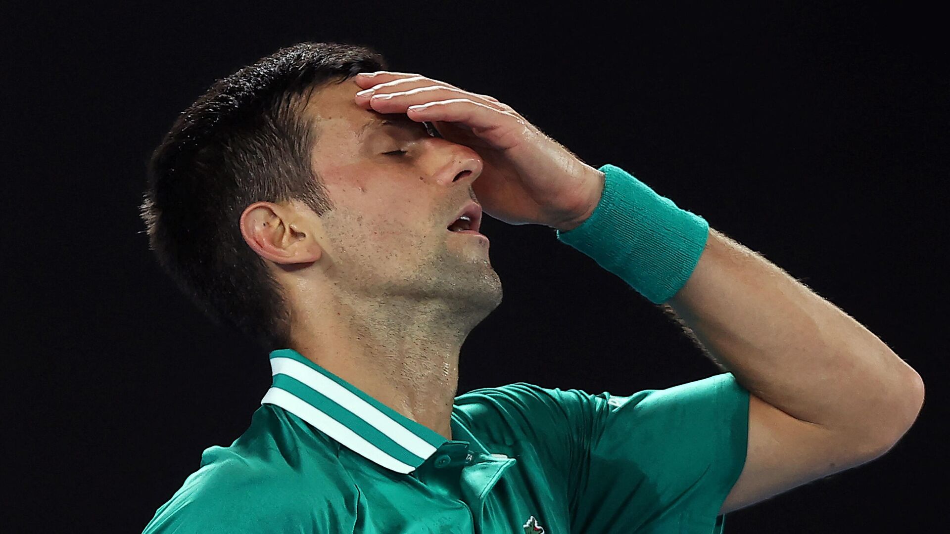 (FILES) This file photo taken on February 16, 2021 shows Serbia's Novak Djokovic reacting after losing a point against Germany's Alexander Zverev during their men's singles quarter-final match on day nine of the Australian Open tennis tournament in Melbourne - Sputnik International, 1920, 14.01.2022