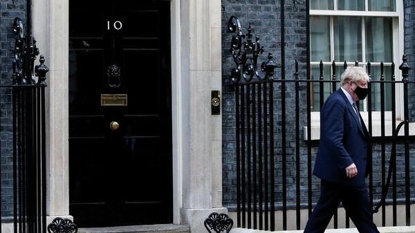 FILE PHOTO: British Prime Minister Johnson walks outside Downing Street in London - Sputnik International