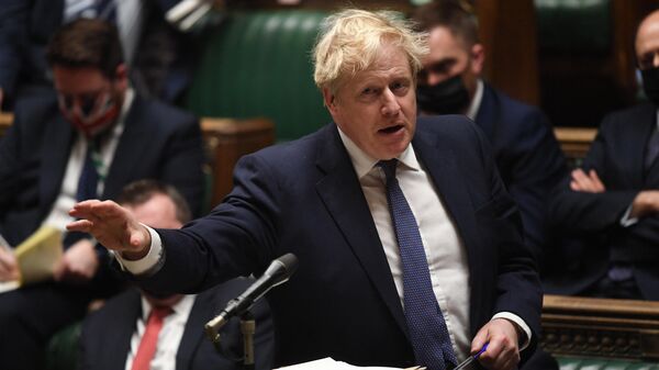 A handout photograph released by the UK Parliament shows Britain's Prime Minister Boris Johnson gesturing during the Prime Minister’s COVID-19 Update in the House of Commons in London on December 15, 2021 - Sputnik International