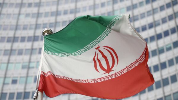 The Iranian flag waves in front of the International Atomic Energy Agency (IAEA) headquarters in Vienna, Austria, March 1, 2021. - Sputnik International