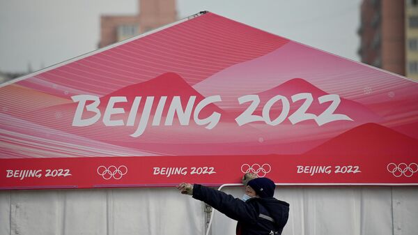 A worker is seen at the entrance of the Wukesong Sports Centre, venue for the ice hockey competition during the 2022 Beijing Winter Olympics, in Beijing on January 18, 2022. - Sputnik International