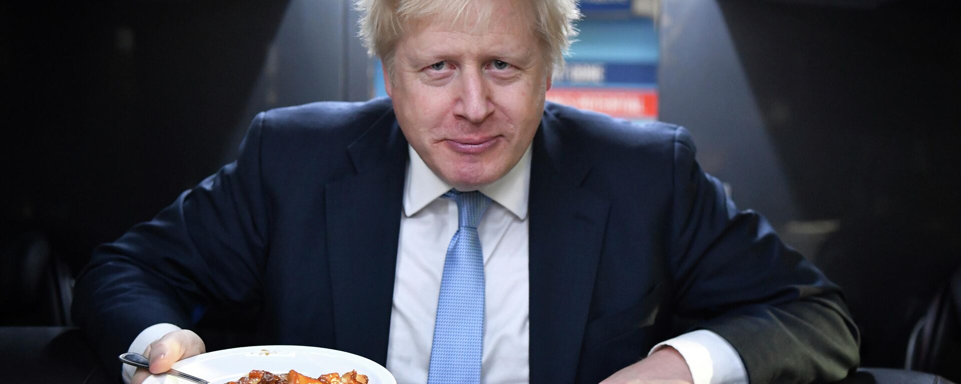 Britain's Prime Minister Boris Johnson eats a portion of pie aboard the Conservative Party campaign bus after a visit to the Red Olive catering company in Derby, central England Wednesday Dec. 11, 2019.  - Sputnik International, 1920, 19.01.2022