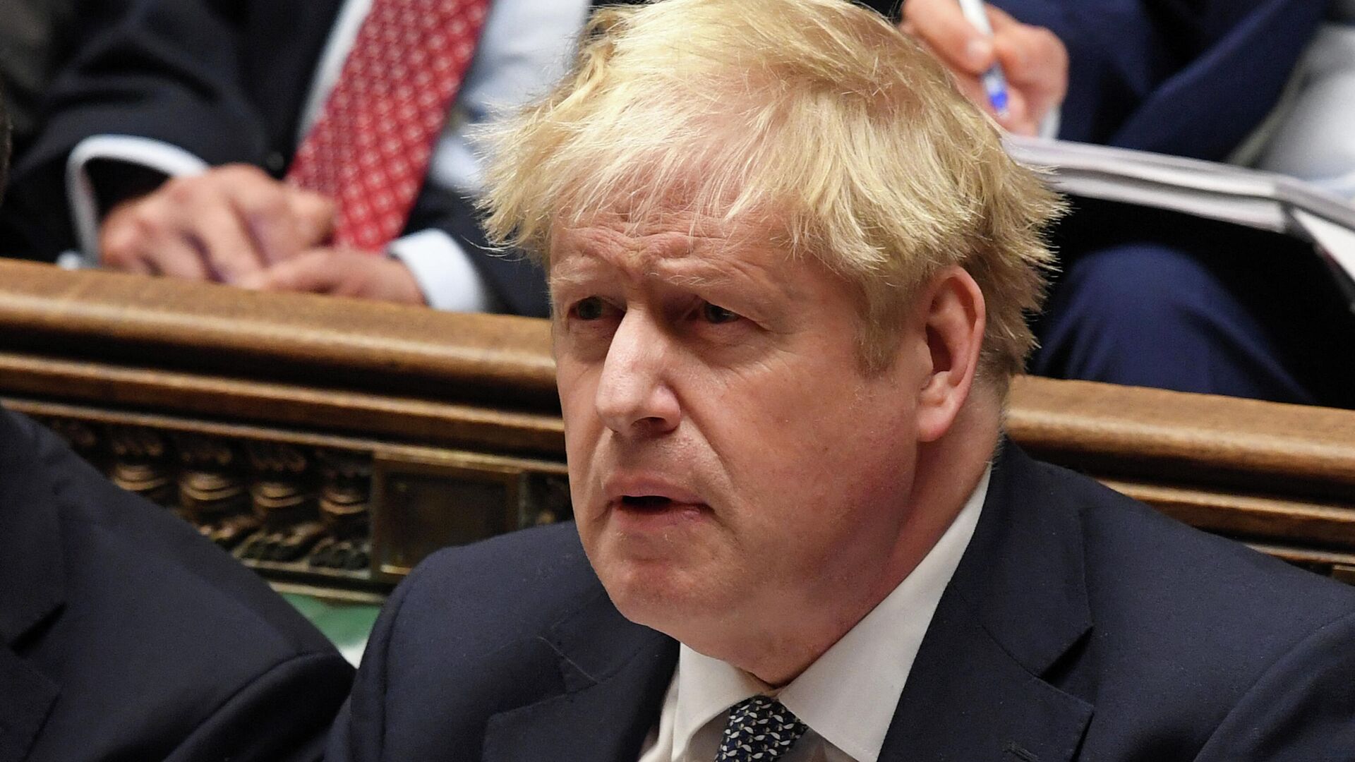 A handout photograph released by the UK Parliament shows Britain's Prime Minister Boris Johnson reacting as Leader of the opposition Labour Party Keir Starmer (unseen) speaks attending Prime Minister's Questions (PMQs) in the House of Commons in London on January 12, 2022. - Sputnik International, 1920, 19.01.2022