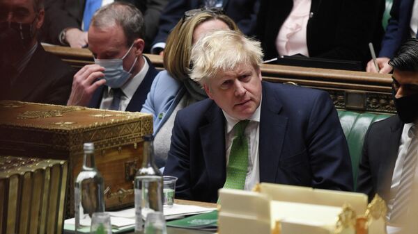 British Prime Minister Boris Johnson listens during the weekly question time debate at Parliament in London, Britain, January 19, 2022.  - Sputnik International