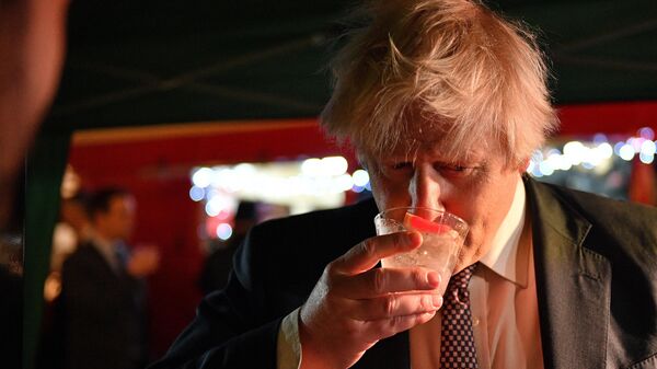 Britain's Prime Minister Boris Johnson samples an Isle of Harris Gin as he visits a UK Food and Drinks market set up in Downing Street, central London on November 30, 2021 - Sputnik International