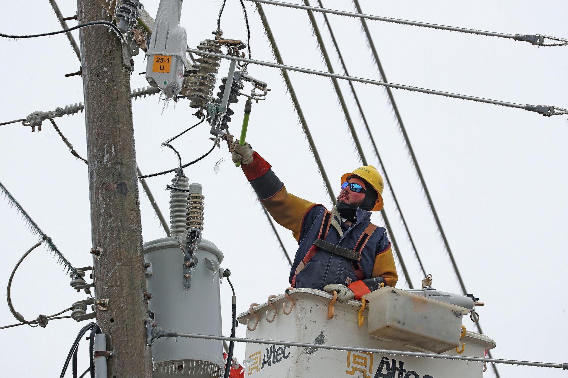 Mike Raniolo with MasTec a contractor for Duke Power breaks ice on power lines after a winter storm hit North Carolina in Atlantic Beach, N.C. on Saturday, Jan. 22, 2022 - Sputnik International, 1920, 22.01.2022