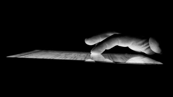 A hand touching the screen - Sputnik International