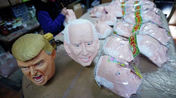 Near the finish products of rubber masks depicting President-elect Joe Biden and President Donald Trump, an employee adds details to the rubber masks at the Ogawa Studios in Saitama, north of Tokyo, Wednesday, Nov. 11, 2020 - Sputnik International