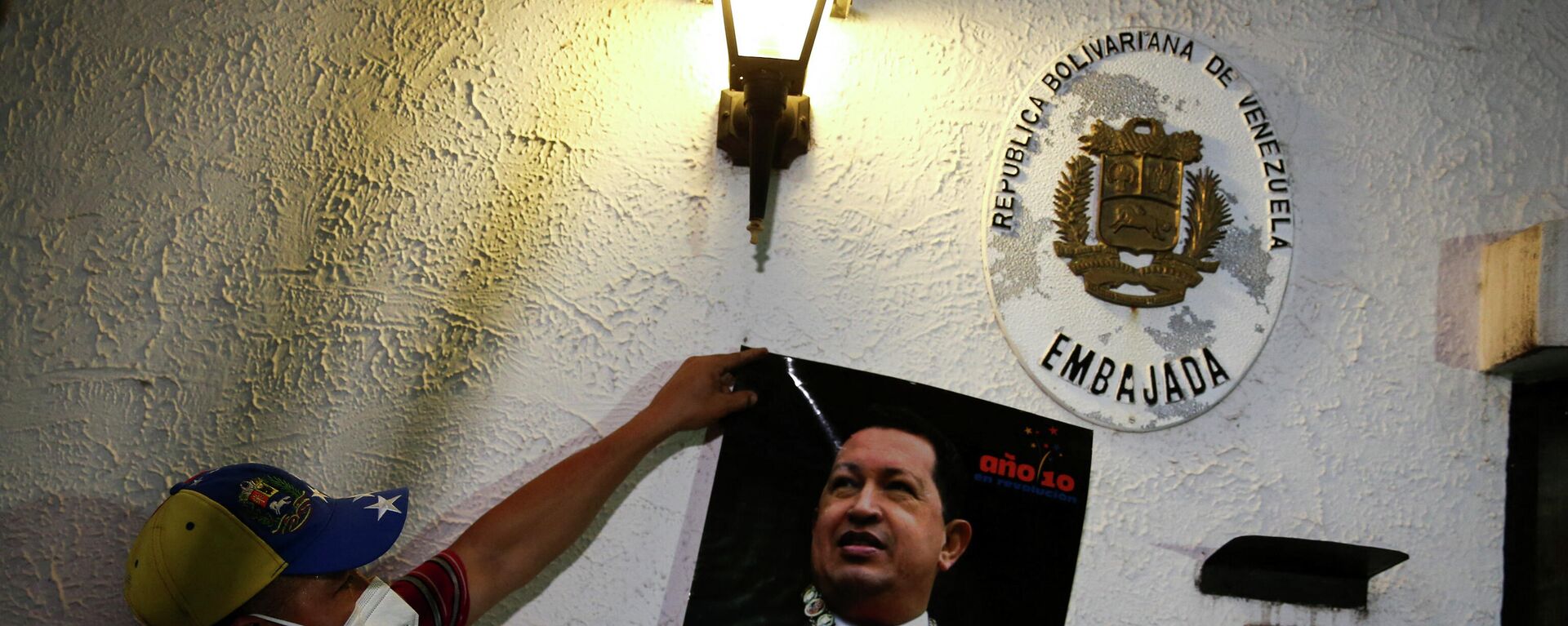 A former employee displays a picture of late former Venezuelan president Hugo Chavez as activists participate in the recovery of the Venezuelan embassy, which had been closed since 2009, in Tegucigalpa, Honduras January 27, 2022.  - Sputnik International, 1920, 28.01.2022