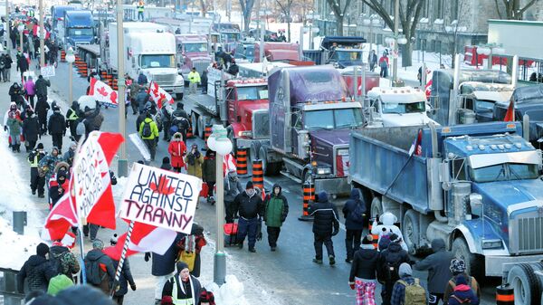 FILE PHOTO: Trucks sit parked on Wellington Street near the Parliament Buildings as truckers and their supporters take part in a convoy to protest coronavirus disease (COVID-19) vaccine mandates for cross-border truck drivers in Ottawa, Ontario, Canada, January 29, 2022.  - Sputnik International