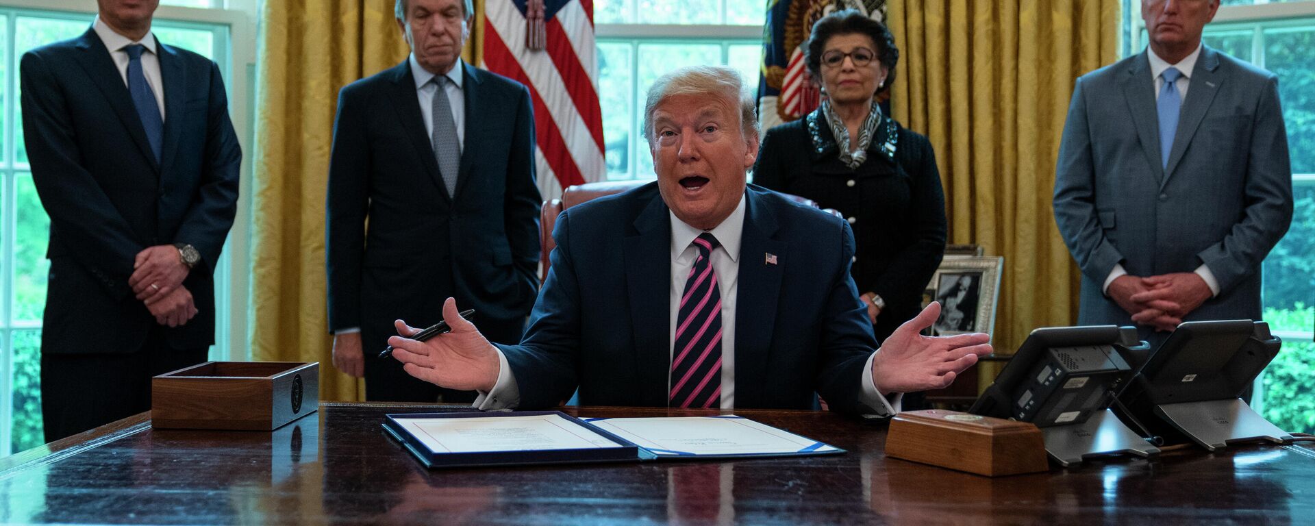 President Donald Trump speaks before signing a coronavirus aid package to direct funds to small businesses, hospitals, and testing, in the Oval Office of the White House, Friday, April 24, 2020, in Washington. From left, Treasury Secretary Steven Mnuchin, Sen. Roy Blunt, R-Mo., Trump, Small Business administrator Jovita Carranza, and House Minority Leader Kevin McCarthy of Calif. (AP Photo/Evan Vucci) - Sputnik International, 1920, 09.06.2023