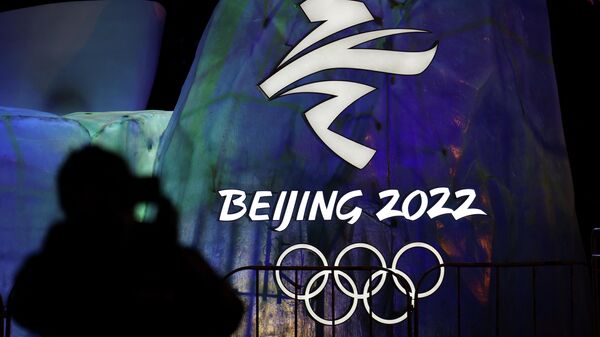 A man photographs an illuminated logo ahead of the Beijing 2022 Winter Olympics in Beijing, China January 26, 2022 - Sputnik International