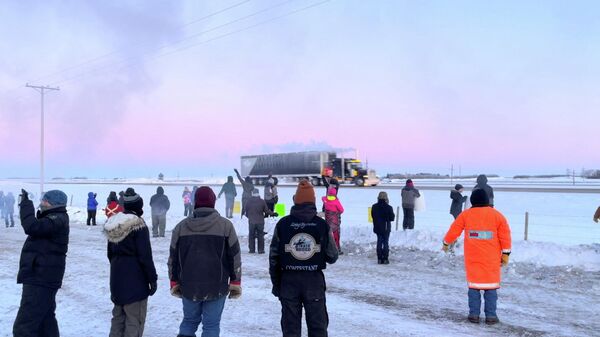 Family, friends and neighbours gather to show support for the freedom convoy on the Trans-Canada highway in Grenfell, Saskatchewan, Canada January 25, 2022 in this screenshot obtained from a video on social media - Sputnik International