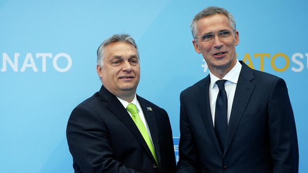 Hungarian Prime Minister Viktor Orban (L) is welcomed by NATO Secretary General Jens Stoltenberg (R) as he arrives for the NATO (North Atlantic Treaty Organization) summit, at the NATO headquarters in Brussels, on July 11, 2018. - Sputnik International