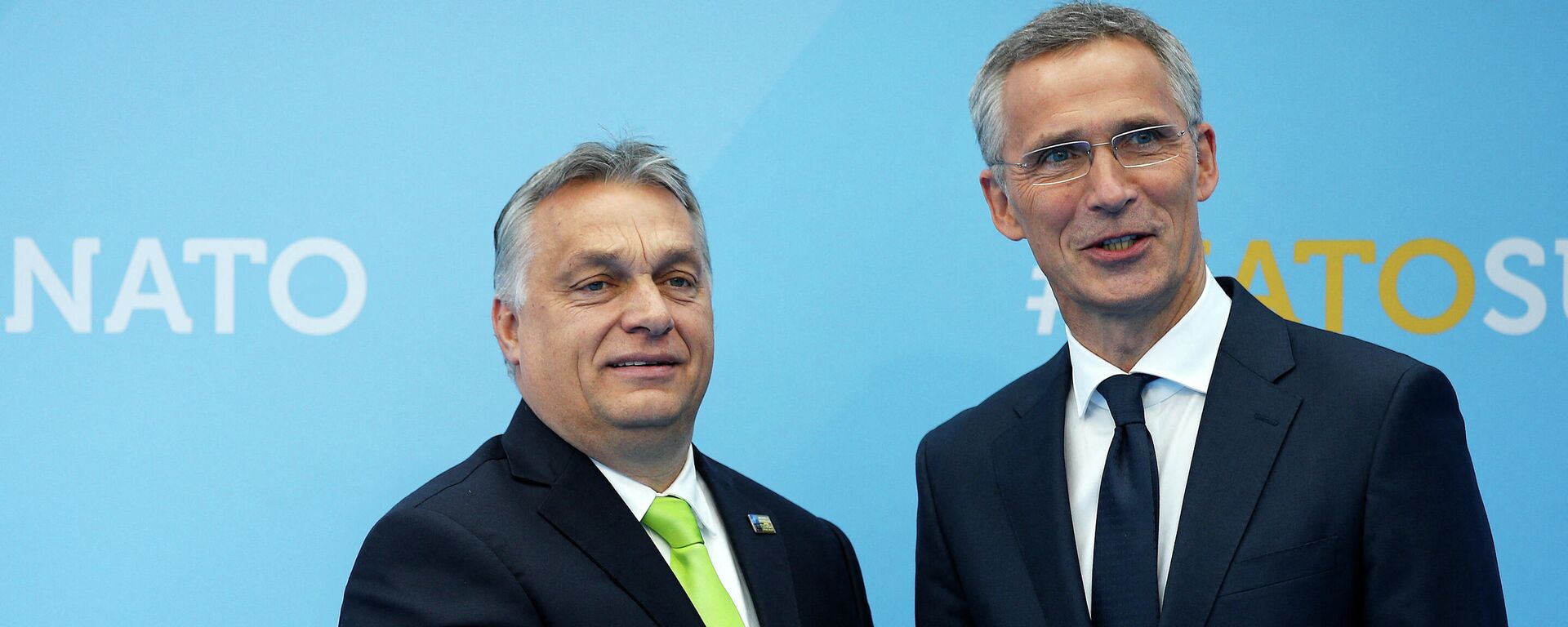 Hungarian Prime Minister Viktor Orban (L) is welcomed by NATO Secretary General Jens Stoltenberg (R) as he arrives for the NATO (North Atlantic Treaty Organization) summit, at the NATO headquarters in Brussels, on July 11, 2018. - Sputnik International, 1920, 24.01.2024