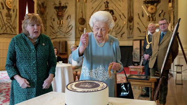 Britain's Queen Elizabeth cuts a cake to celebrate the start of the Platinum Jubilee during a reception at the Ballroom of Sandringham House, which is the Queen's Norfolk residence, in Sandringham, Britain - Sputnik International