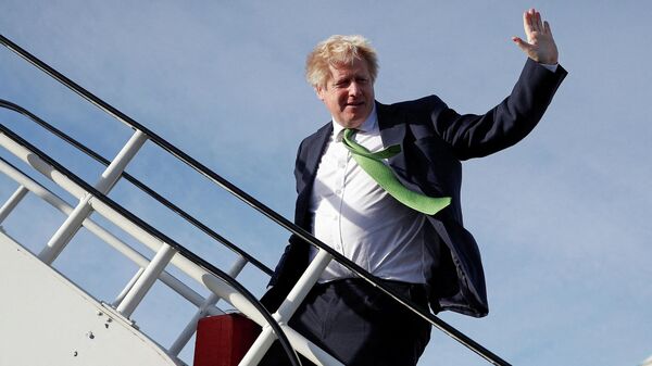 Britain's Prime Minister Boris Johnson waves as he boards an aircraft in London, on 1 February 2022, before departing for Kiev, to meet with Ukraine's President Volodymyr Zelensky. - Sputnik International