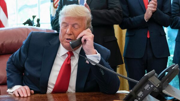  In this Oct. 23, 2020, photo, President Donald Trump talks on a phone during a call with the leaders of Sudan and Israel in the Oval Office of the White House, in Washington.  - Sputnik International