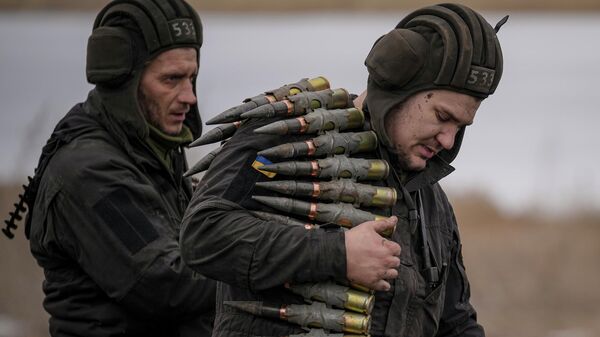 A Ukrainian serviceman carries large caliber ammunitions for armored fighting vehicles mounted weapons during an exercise in a Joint Forces Operation controlled area in the Donetsk region, eastern Ukraine, Feb. 10, 2022. - Sputnik International