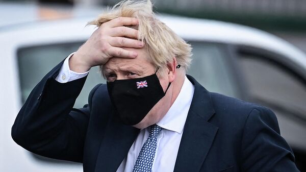 Britain's Prime Minister Boris Johnson reacts as he arrives at the Brussels' military airport following his meeting with NATO Secretary General, and prior to take off for Warsaw, on February 10, 2022 - Sputnik International