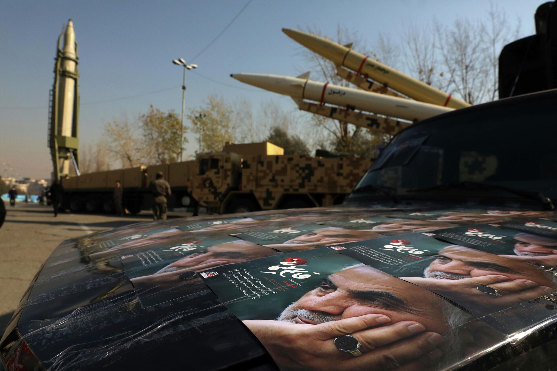 Posters of Iranian Gen. Qassem Soleimani, who was killed in Iraq in a U.S. drone attack in Jan. 3, 2020, are seen in front of Qiam, background left, Zolfaghar, top right, and Dezful missiles displayed in a missile capabilities exhibition by the paramilitary Revolutionary Guard a day prior to second anniversary of Iran's missile strike on U.S. bases in Iraq in retaliation for killing Gen. Soleimani, at Imam Khomeini grand mosque, in Tehran, Iran, Friday, Jan. 7, 2022. Iran put three ballistic missiles on display on Friday, as talks in Vienna aimed at reviving Tehran's nuclear deal with world powers flounder.  - Sputnik International, 1920, 21.04.2024