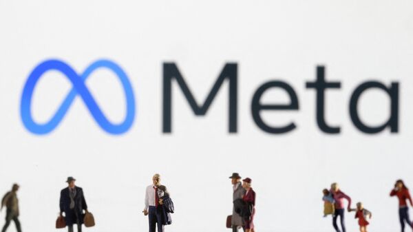Small figurines are seen in front of displayed Meta logo - Sputnik International
