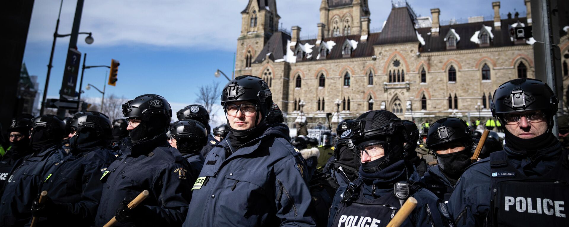 Police block protesters after taking the main street where trucks are parked in Ottawa near Parliament hill  on Saturday, Feb. 19, 2022.  Police resumed pushing back protesters on Saturday after arresting more than 100 and towing away vehicles in Canada’s besieged capital, and scores of trucks left under the pressure, raising authorities’ hopes for an end to the three-week protest against the country’s COVID-19 restrictions.  (AP Photo/Robert Bumsted) - Sputnik International, 1920, 20.02.2022