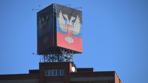 Donetsk People's Republic flag and coat of arms on a building - Sputnik International