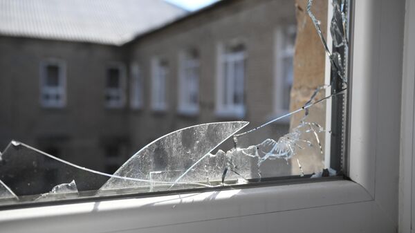 A broken school window is seen after a recent shelling of the Petrovsky district of Donetsk, DPR, Ukraine - Sputnik International