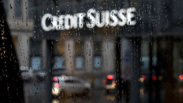 A picture taken on June 13, 2016 shows a branch of Swiss banking giant Credit Suisse behind a window under the rain, in Basel - Sputnik International