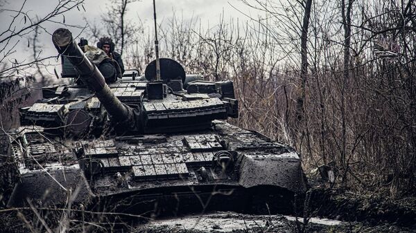 A service member of the Ukrainian Naval Infantry Corps (Marine Corps) rides a tank during drills at a training ground in an unknown location in Ukraine, in this handout picture released February 18, 2022 - Sputnik International