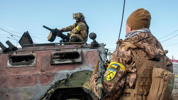 Ukrainian soldiers inspect a damaged military vehicle after fighting in Kharkov, Ukraine. File photo - Sputnik International