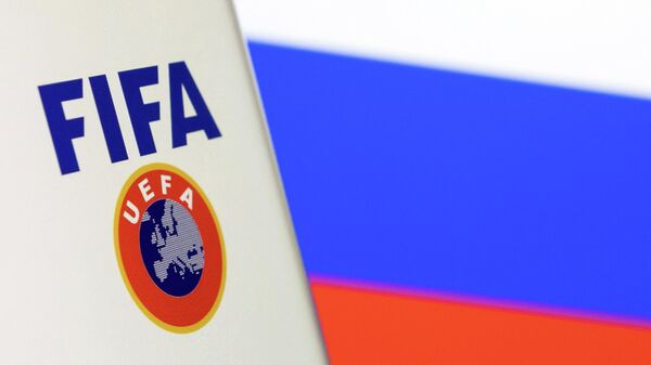 FIFA and UEFA logos are displayed in front of the Russian flag in this illustration taken, February 28, 2022 - Sputnik International