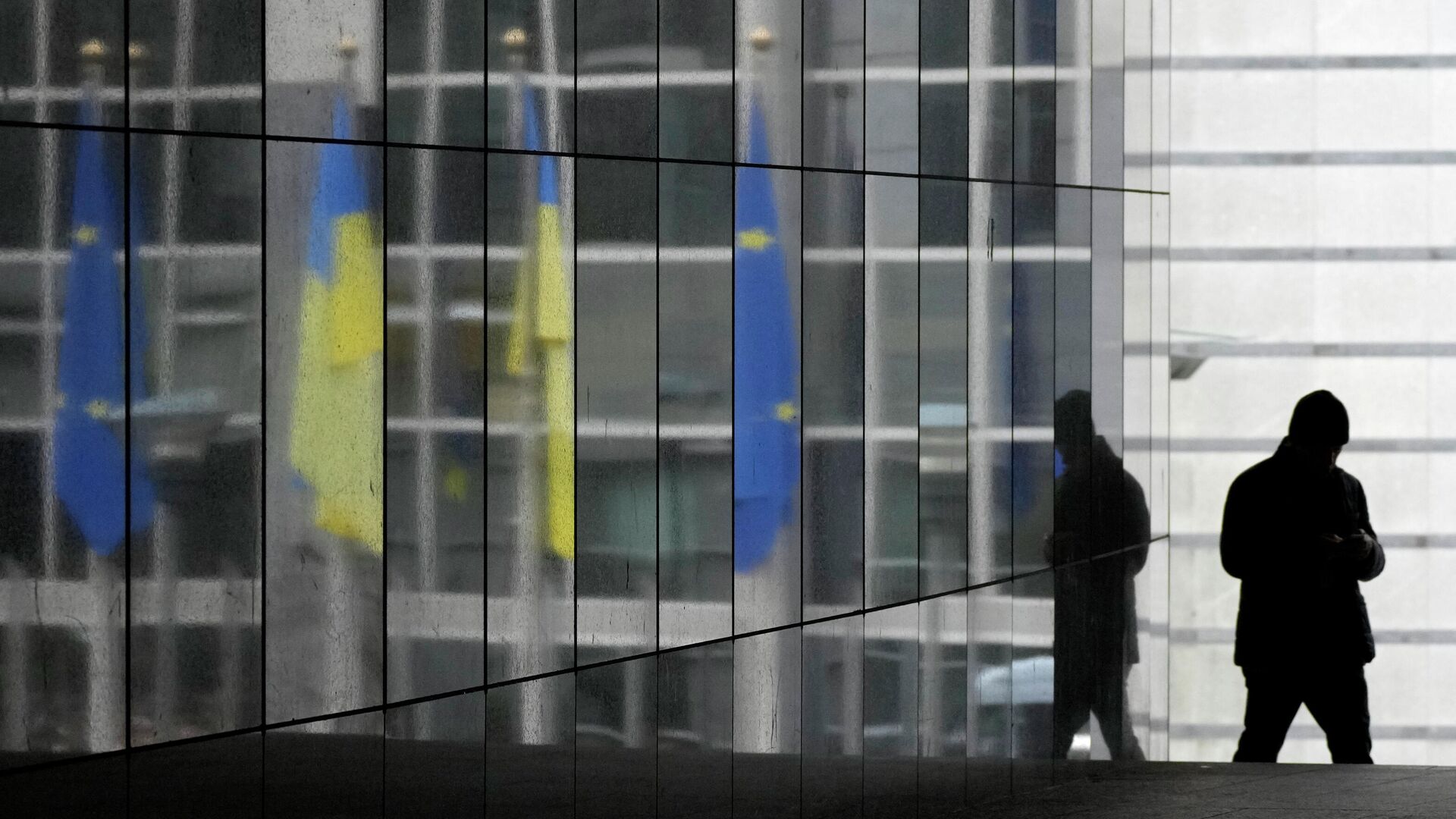 Ukraine and European Union flags are reflected onto a marble wall as a visitor walks by prior to an extraordinary plenary session on Ukraine at the European Parliament in Brussels, Tuesday, March 1, 2022 - Sputnik International, 1920, 01.03.2022