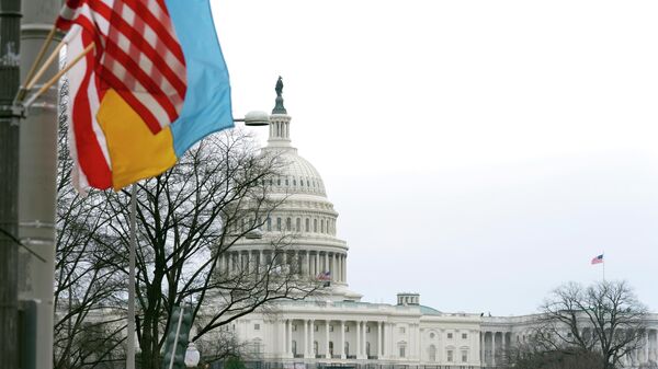 The U.S. Capitol is seen behind the U.S. flag, Ukrainian flag and the flag of Washington, D.C., in Washington, Tuesday, March, 1, 2022. President Joe Biden will deliver his first State of the Union address at a precipitous moment for the nation. Biden is aiming to navigate the country out of a pandemic, reboot his stalled domestic agenda and confront Russia’s aggression. - Sputnik International