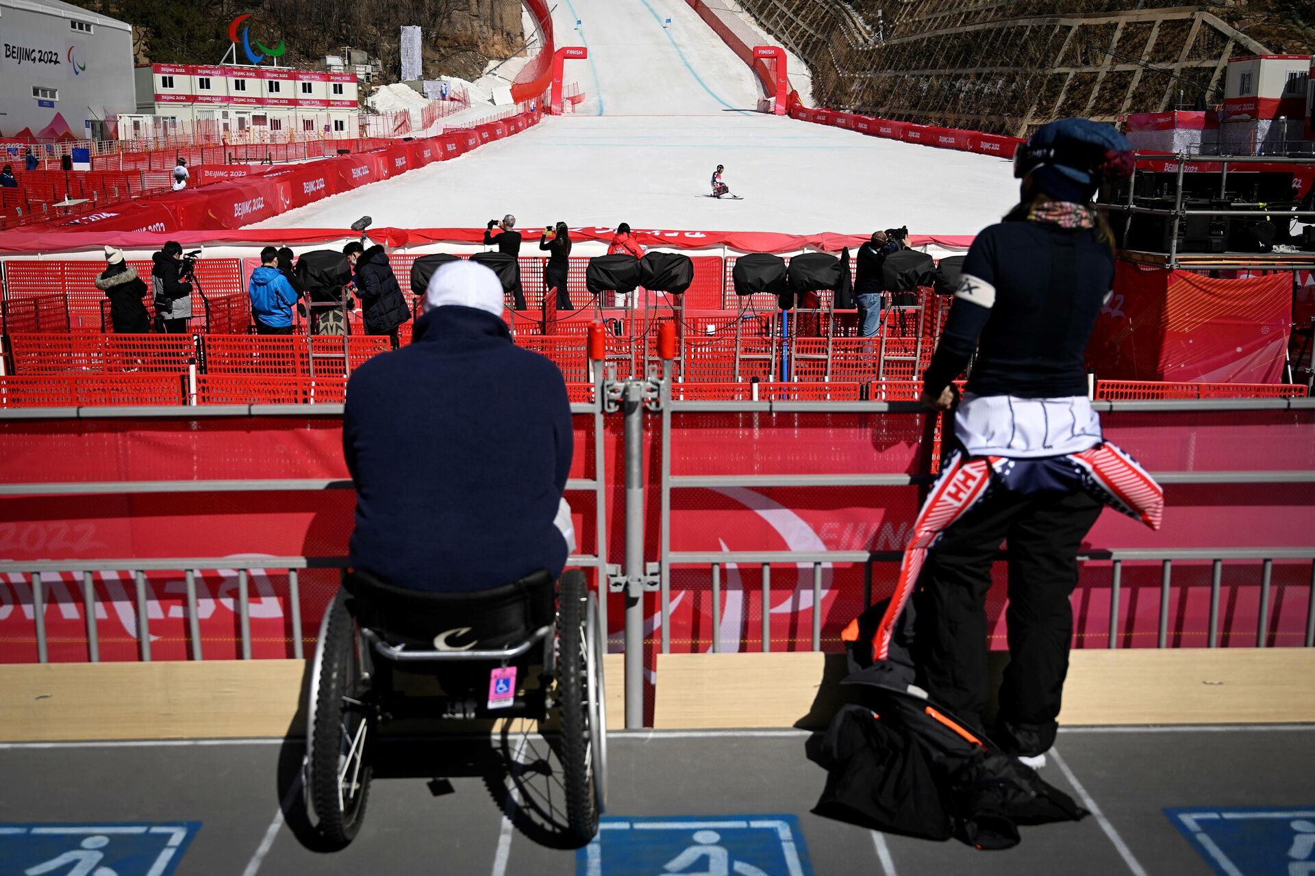 A paralympic athlete crosses the finish line during a training session for the men's downhill sitting event at the Yanqing National Alpine Skiing Centre in Yanqing ahead of the Beijing 2022 Winter Paralympic Games on March 3, 2022. - Sputnik International, 1920, 04.03.2022