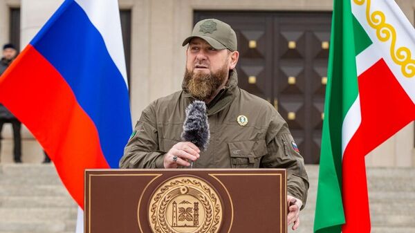 In this handout photo released by the press service of the Head of Chechen Republic, Head of the Chechen Republic Ramzan Kadyrov takes part in a review of the Chechen Republic's troops and military hardware in Grozny, Chechen Republic, Russia - Sputnik International