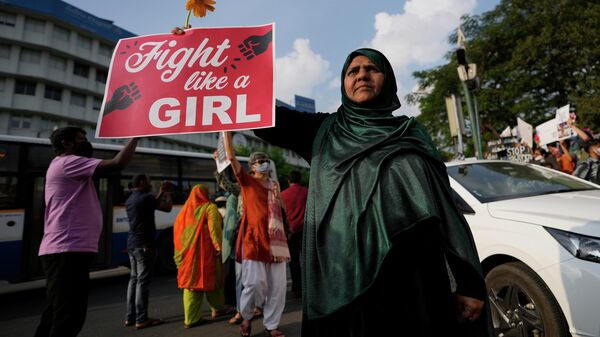 An Indian woman holds a placard as she participates in a march to mark International Women's Day in Bengaluru, India, Sunday, March 6, 2022.  - Sputnik International