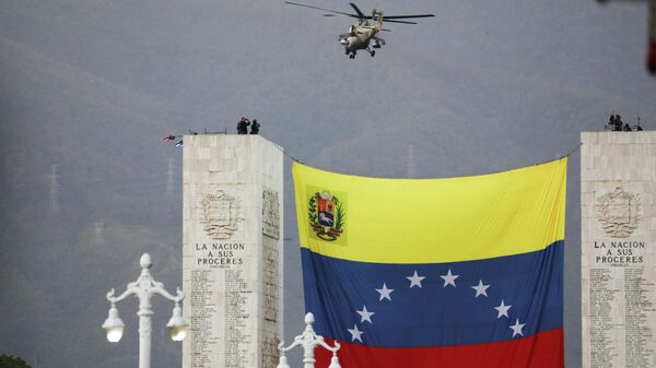 A helicopter flies over a large Venezuelan flag during a military parade to celebrate the 210th anniversary of Venezuela's independence in Caracas, Venezuela, July 5, 2021. - Sputnik International