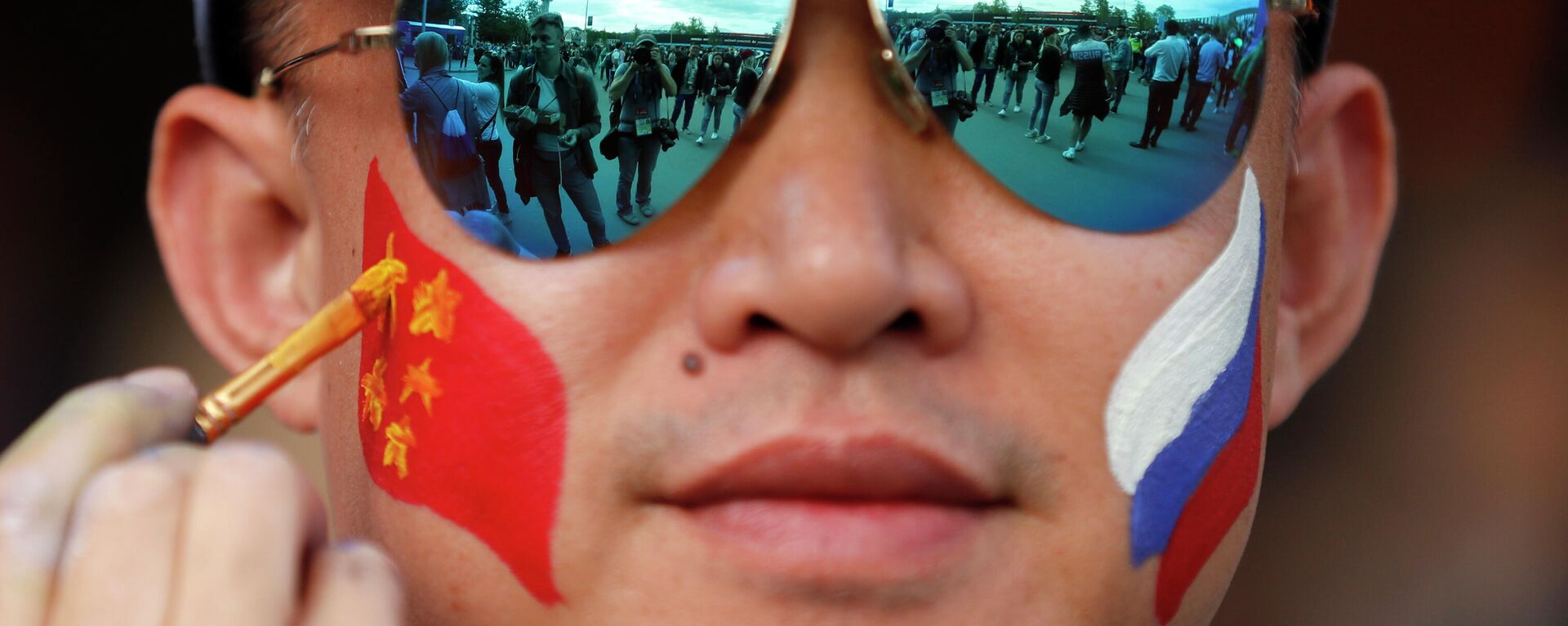 A fan gets a Chinese flag painted onto his face (File) - Sputnik International, 1920, 01.12.2022