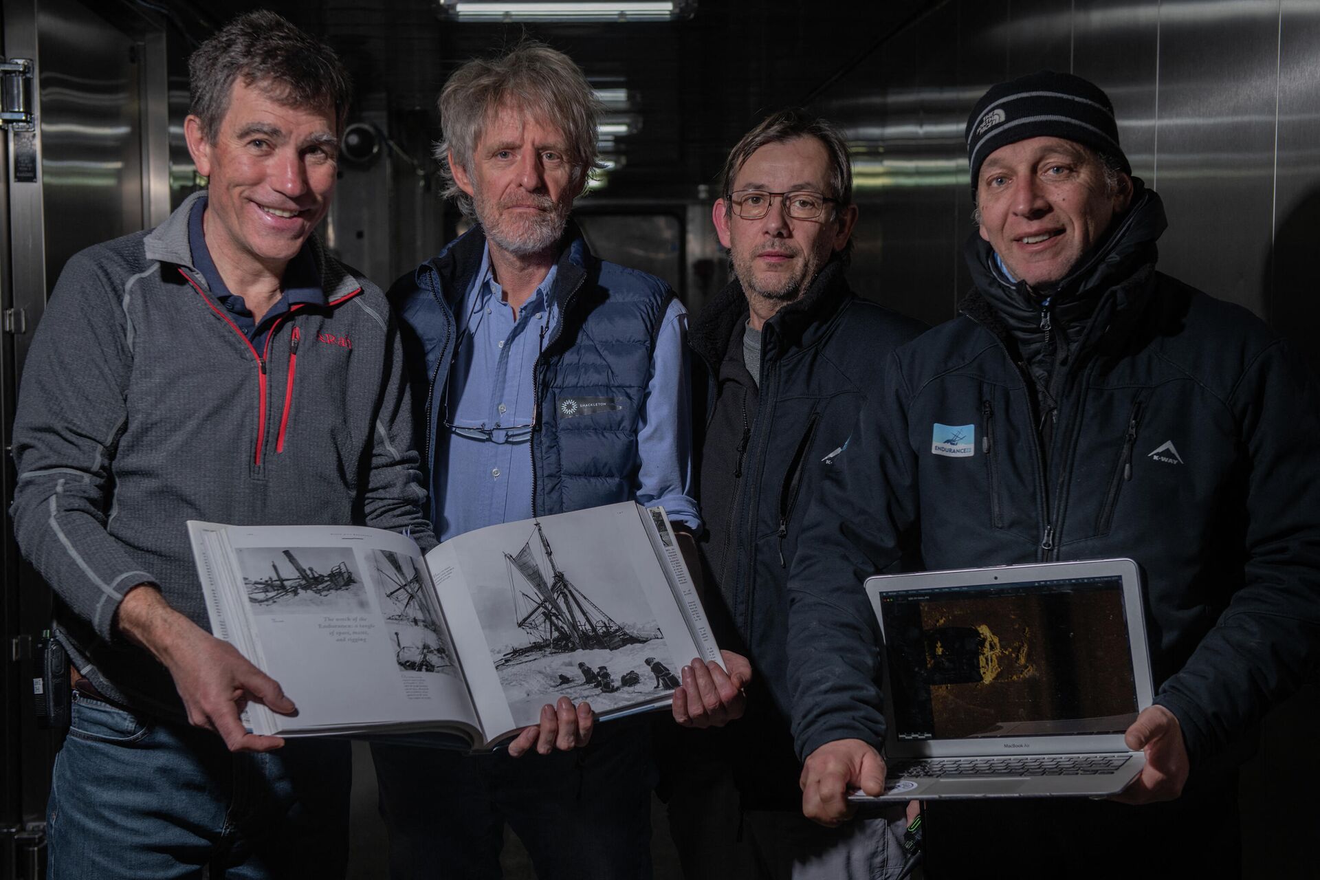 This handout picture taken in Antarctica's Weddell sea on March 5, 2022, and released by the Falklands Maritime Heritage Trust shows (From L) John Shears, Endurance22 Expedition Leader, Mensun Bound, Director of Exploration, Nico Vincent, Expedition Sub-Sea Manager, JC Caillens, Off-Shore Manager with the first scan of the wreck and photos of Frank Hurley. - One of the world's most storied shipwrecks, Ernest Shackleton's Endurance, has been discovered off the coast of Antarctica more than a century after its sinking, explorers announced on March 9. Endurance was discovered at a depth of 3,008 metres (9,869 feet) in the Weddell Sea, about four miles from where it was slowly crushed by pack ice in 1915 - Sputnik International, 1920, 09.03.2022