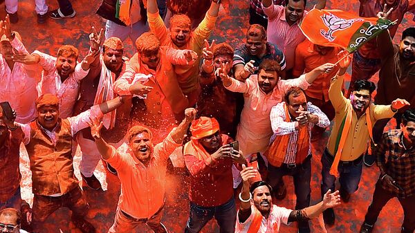 Supporters of India's Bharatiya Janata Party (BJP) celebrate outside the party office in Lucknow on March 10, 2022, on the day of counting of votes for the Uttar Padesh state asembly elections - Sputnik International